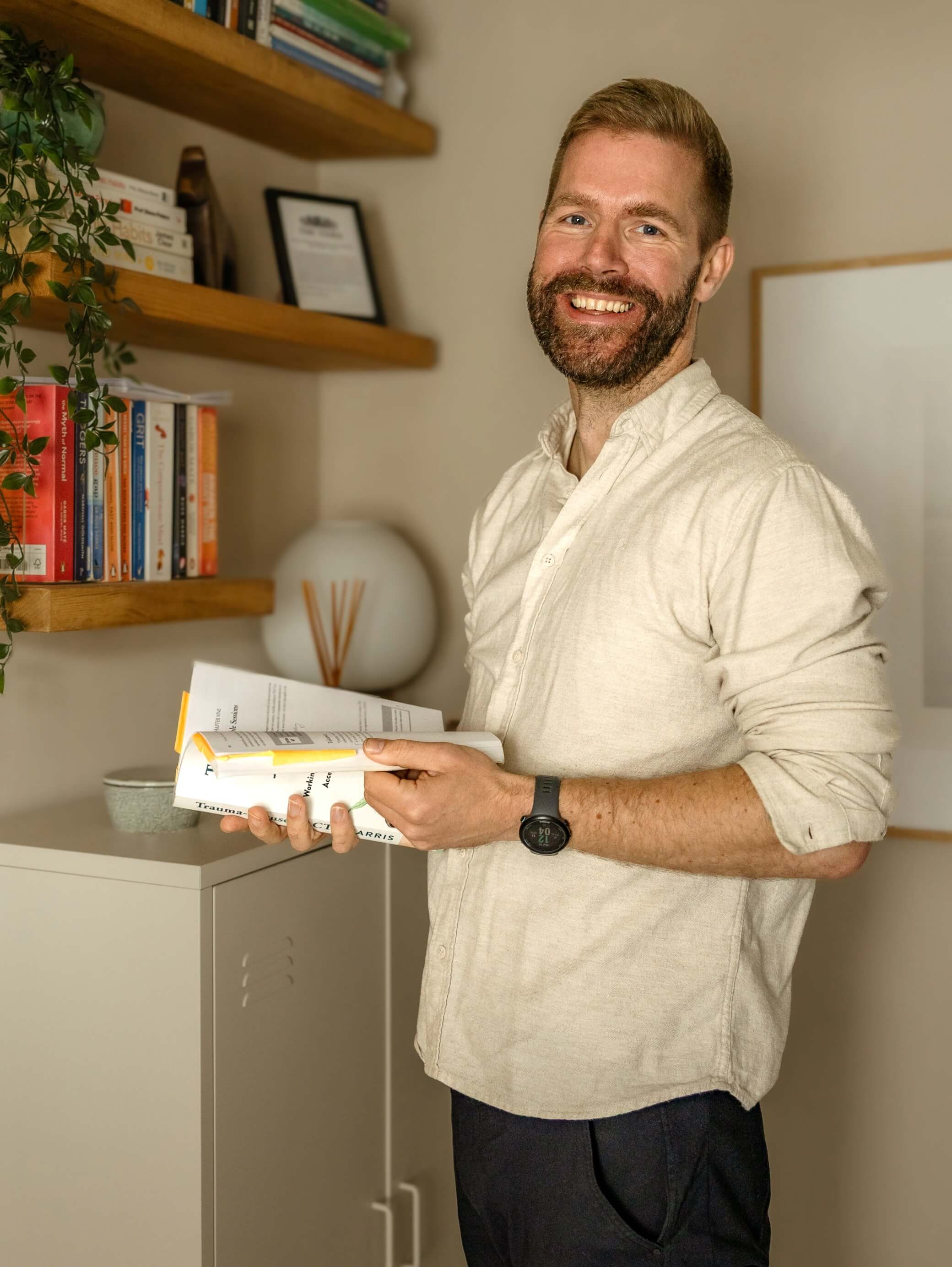 Owner of Neurodiverse Coaching standing in his office.