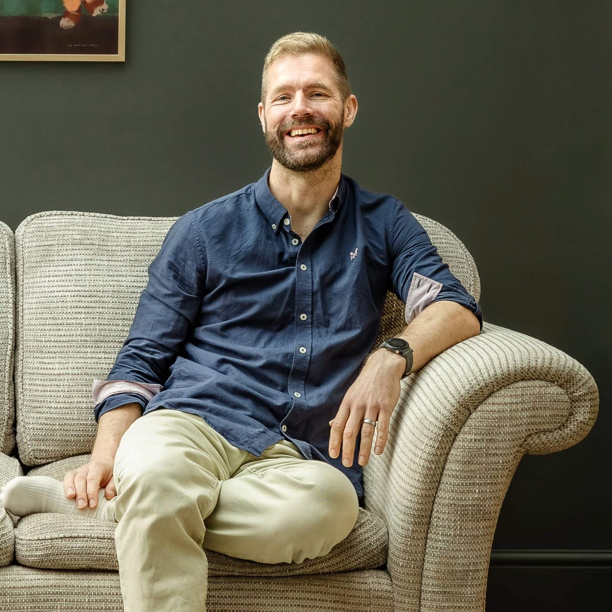 Nick sitting down on a sofa.